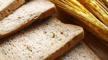 Slices of bread and wheat are shown on a table video