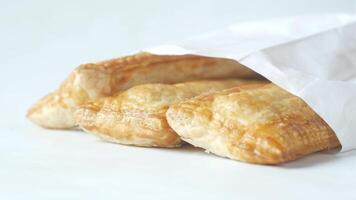 A bag of pastry is sitting on top of a white surface video