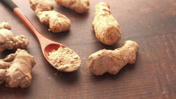 Ginger root and powder on a wooden table video