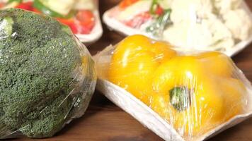 A bunch of broccoli and peppers wrapped in plastic video