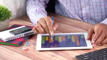 Man using tablet to create a graph video
