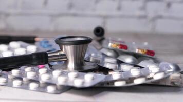 A stethoscope and a pile of pills on a table video