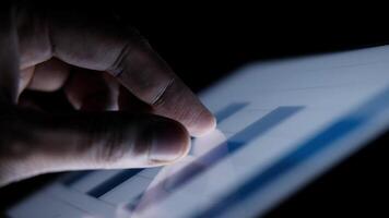 A person is using a tablet computer with a graph on it video