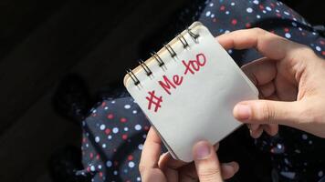 A person holding a notebook with the word meh written on it video