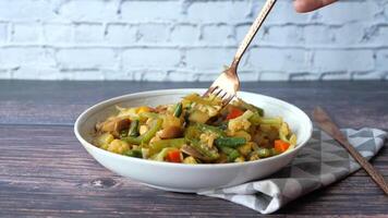 A bowl of vegetables and rice with a fork video