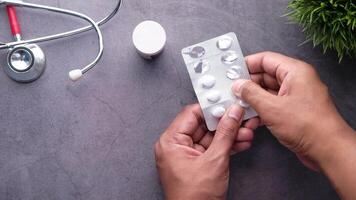 A person holding a pill in front of a stethoscope video