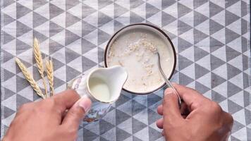 A person holding a spoon over a bowl of cereal video