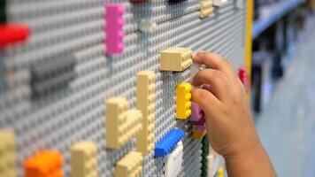 A child playing with lego blocks in a store video