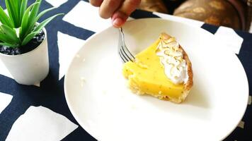 A person is holding a fork and knife over a piece of pie video