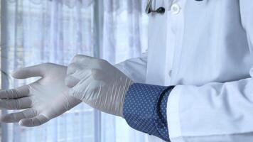 A doctor wearing a white coat and gloves video