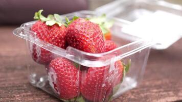 A plastic container with strawberries in it video