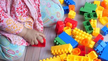 A child playing with lego blocks on the floor video