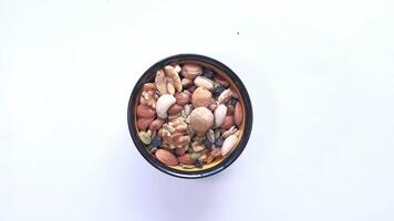 A bowl full of nuts and nuts on a white background video