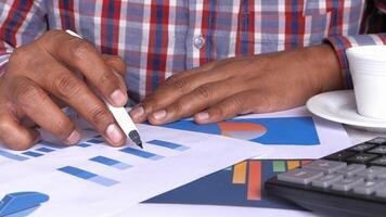 A man is using a calculator to calculate the profit of his business video