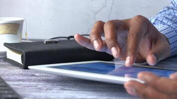 A person is using a tablet computer with their hands video