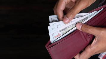 A person holding a wallet with money in it video