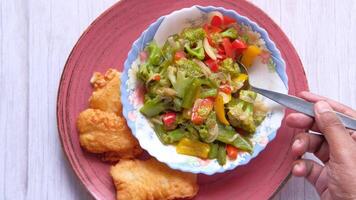 A plate with a bowl of food and a knife video