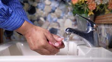 A person washing their hands in a bathroom sink video