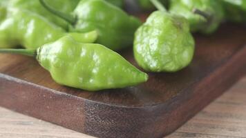 A group of green peppers on a wooden cutting board video