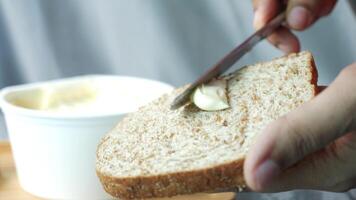A person is spreading butter on a piece of bread video