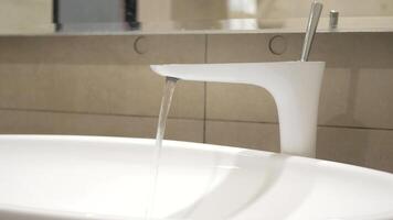 A modern bathroom sink with a white faucet video