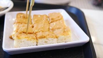 A square of cake with peanut butter on top video
