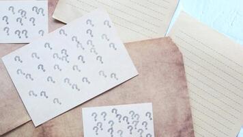 Several pieces of paper with question marks on them video