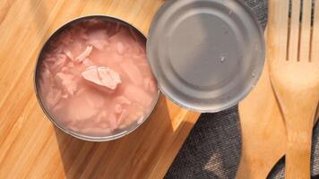 A can of tuna sitting on a table with a fork and spoon video