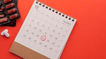Calendar with pills and calendar on red background video