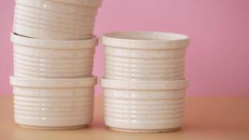 Stylishly Stacked White Ceramic Pots Lined Up Beautifully Against a Soft and Subtle Background video