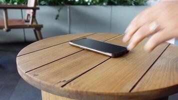 man hand picking up smart phone mobile to receive a call video