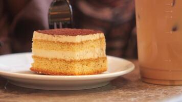 A scrumptious layered cake paired with a delightful coffee beverage beautifully placed on the table video