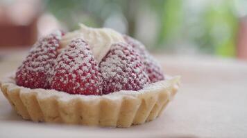 Enjoy a tasty Strawberry Tart with Cream and Powdered Sugar for a delightful treat video