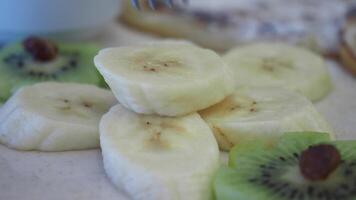 Freshly Sliced Bananas and Kiwis Beautifully Arranged on a Light, Airy Background video