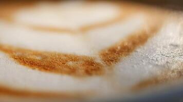 A closeup view showcasing the intricate and beautiful latte art on a coffee surface video