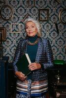 Elegant elderly woman in luxury wear radiating confidence and wealth while standing at retro style house photo