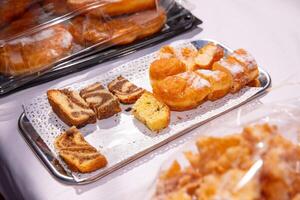 Assorted pastries, cakes on a tray at bakery event, colorful baked goods concept photo