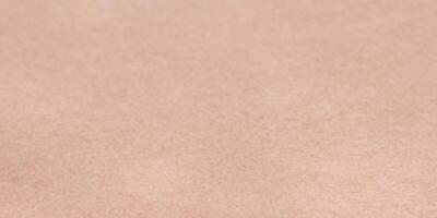 Close-up of smooth kraft paper texture background for design projects photo