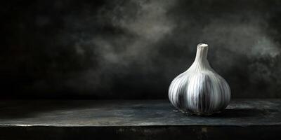 Moody black garlic still life on dark textured background photo