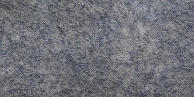 Textured gray stone surface for backgrounds and design concepts photo
