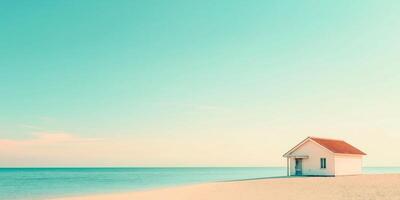Tranquil beach scene with white house under blue sky photo