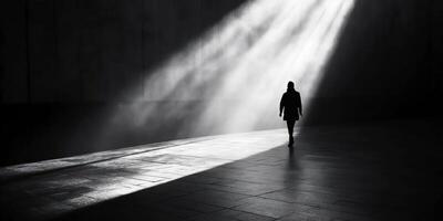 Solitary figure walking in light and shadow embracing solitude and mystery photo
