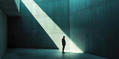 Solitary figure in dramatic light exploring architectural space photo