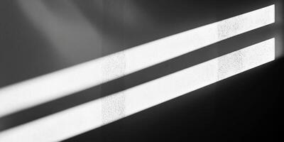 Abstract light patterns on a textured wall creating dynamic contrast and shadow play photo