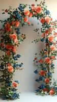 Beautiful floral archway covered in red roses leading to a field of wheat photo