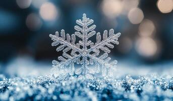 A snowflake is on the ground in front of a blue sky. The snowflake is surrounded by a blue and white background photo