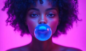 A woman with curly hair is blowing bubbles. The bubbles are blue and the woman is looking at the camera. The image has a fun and playful mood, as the woman is enjoying herself while blowing bubbles photo