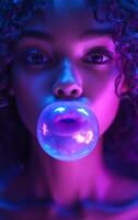 A woman is blowing bubbles in a purple light. The bubbles are glowing and the woman's face is illuminated by the light. The image has a dreamy, ethereal quality to it photo