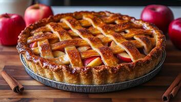 A pie with lattice crust and apples on top. The pie is on a wooden table. The pie is golden brown and looks delicious photo