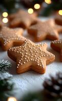 A close up of a star shaped cookie with white icing and sprinkles. The cookie is surrounded by pine needles and is placed on a white background photo